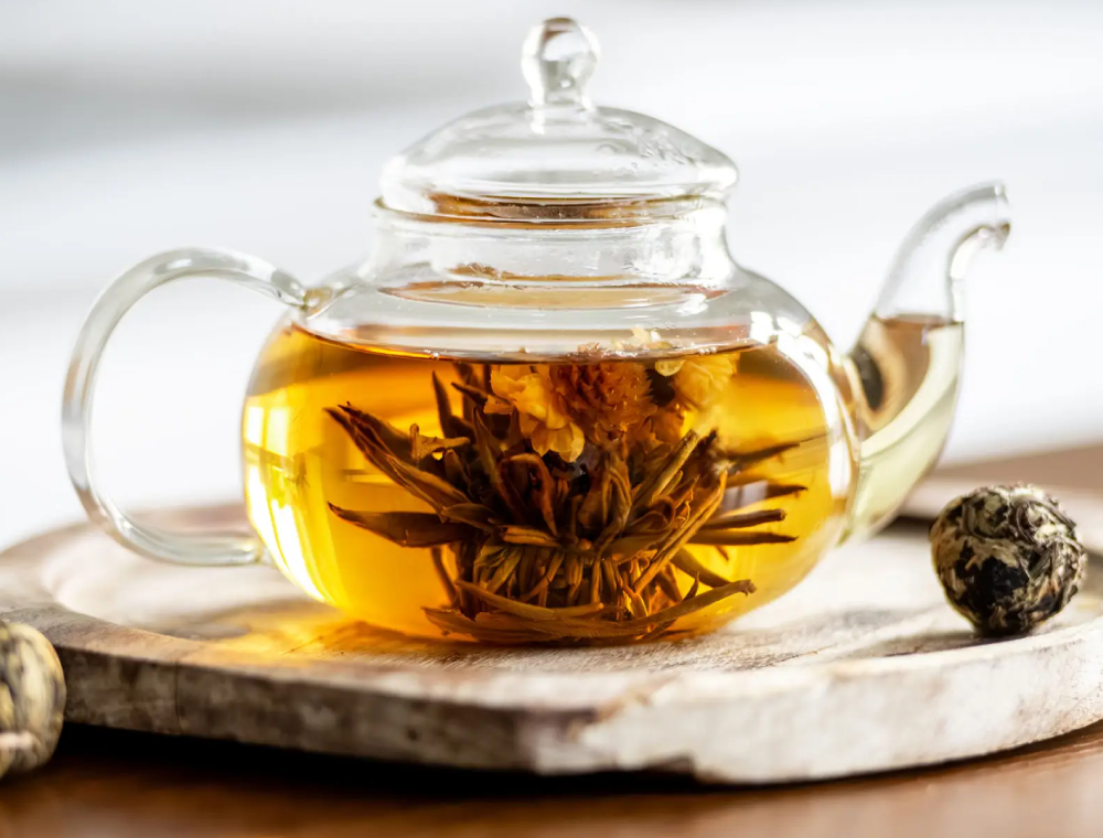 Glass teapot with blooming tea flower