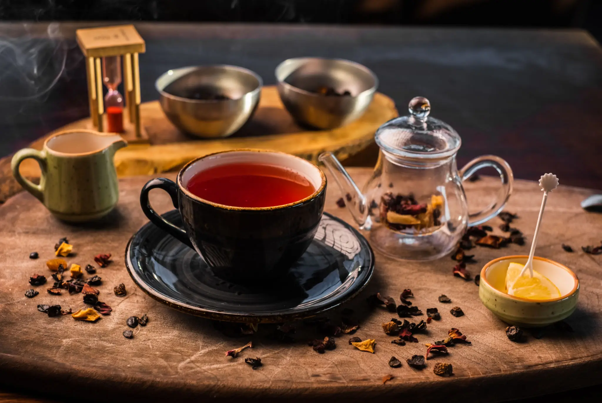Black cup of tea with loose leaves